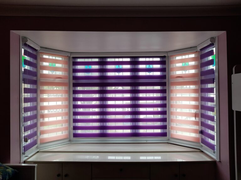 Day and night blinds in a bay window, fitted by HomeDecisions
