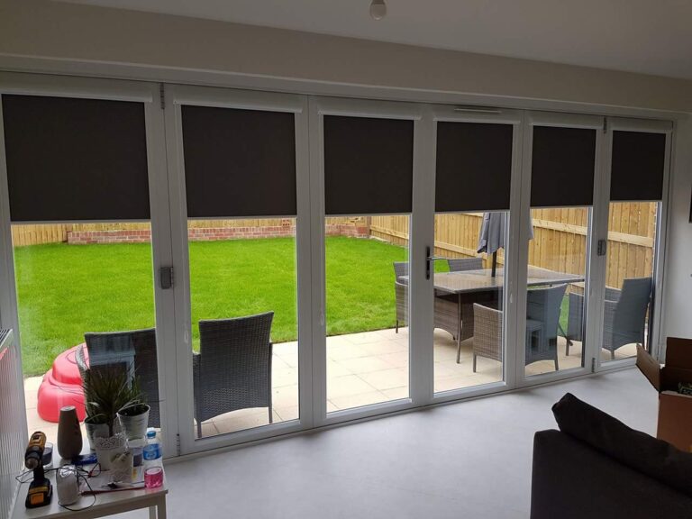 Roller blinds on bi-fold doors, fitted by HomeDecisions